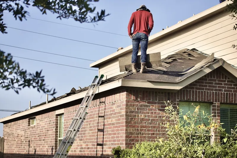 Professional roofer working on a residential roof in Hopeville